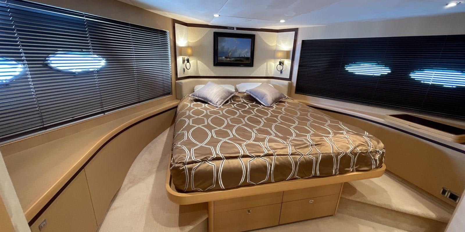 a room with a bed and a television aboard PRINCESS 21M Yacht for Sale