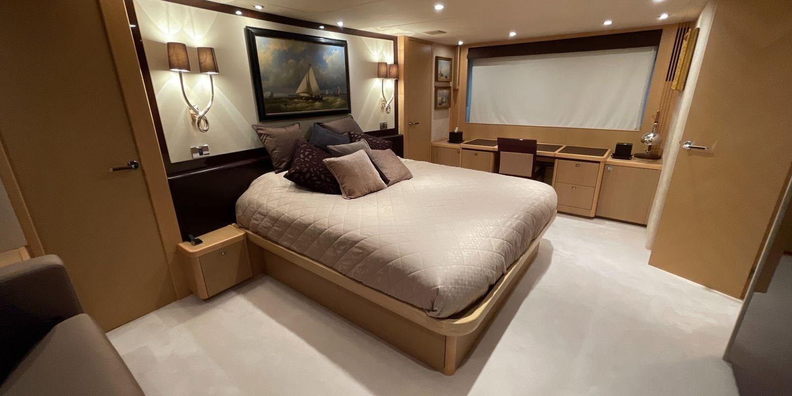 a large bedroom with a large bed aboard PRINCESS 21M Yacht for Sale