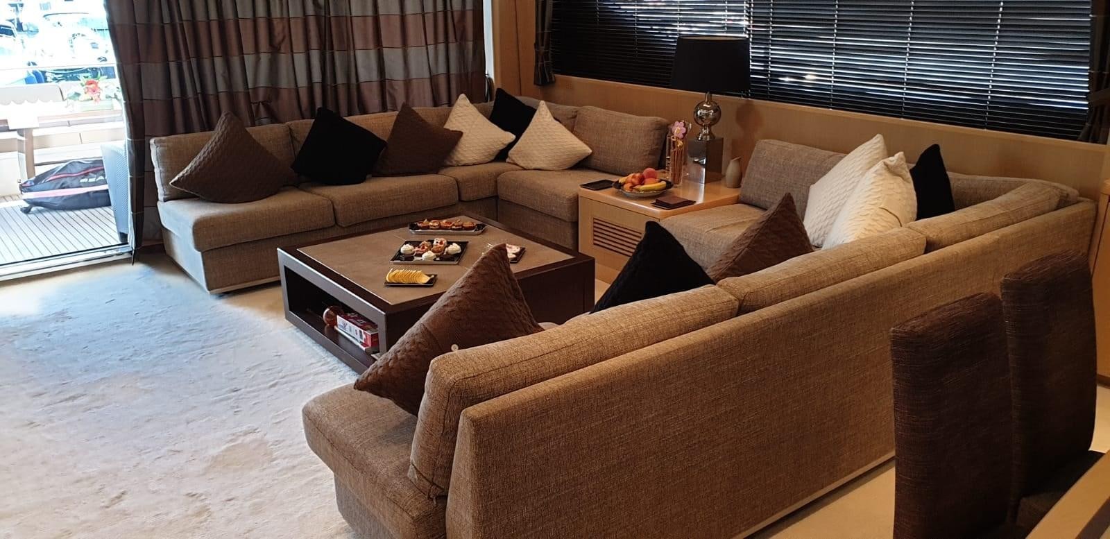 a living room with a couch and a coffee table aboard PRINCESS 21M Yacht for Sale