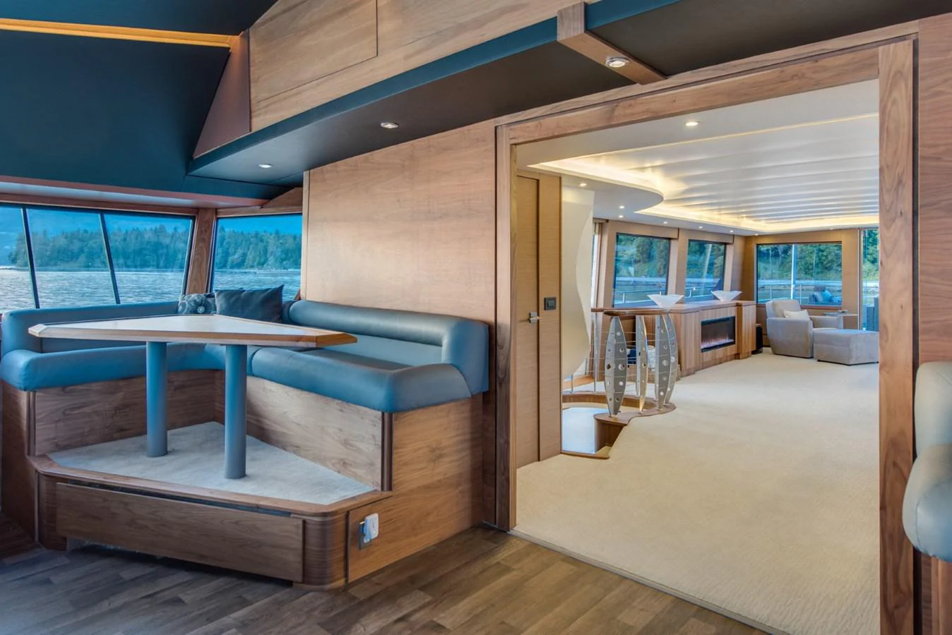 a living room with a blue couch aboard ASCENTE Yacht for Sale
