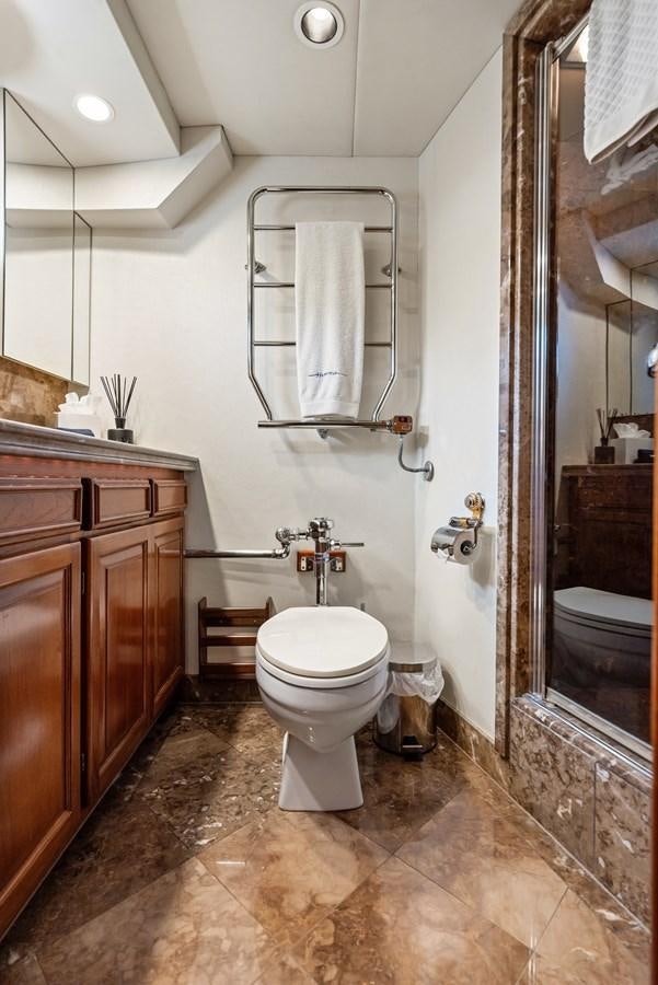 a bathroom with a toilet and a sink aboard HUNTRESS Yacht for Sale