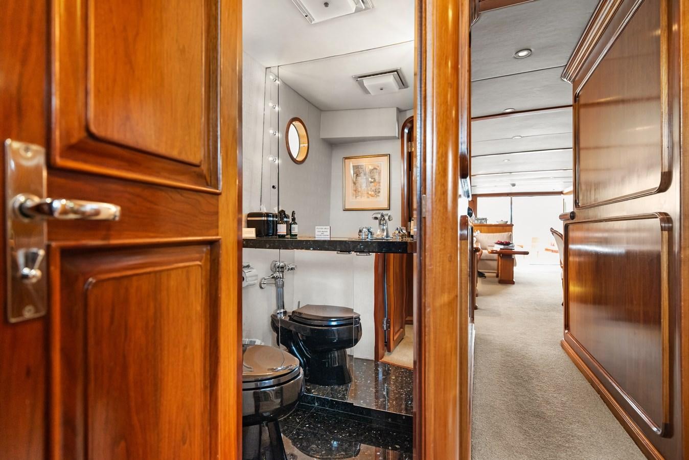 a bathroom with wood cabinets aboard HUNTRESS Yacht for Sale