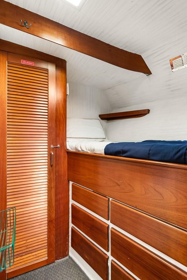 a room with a bed and a closet aboard HUNTRESS Yacht for Sale