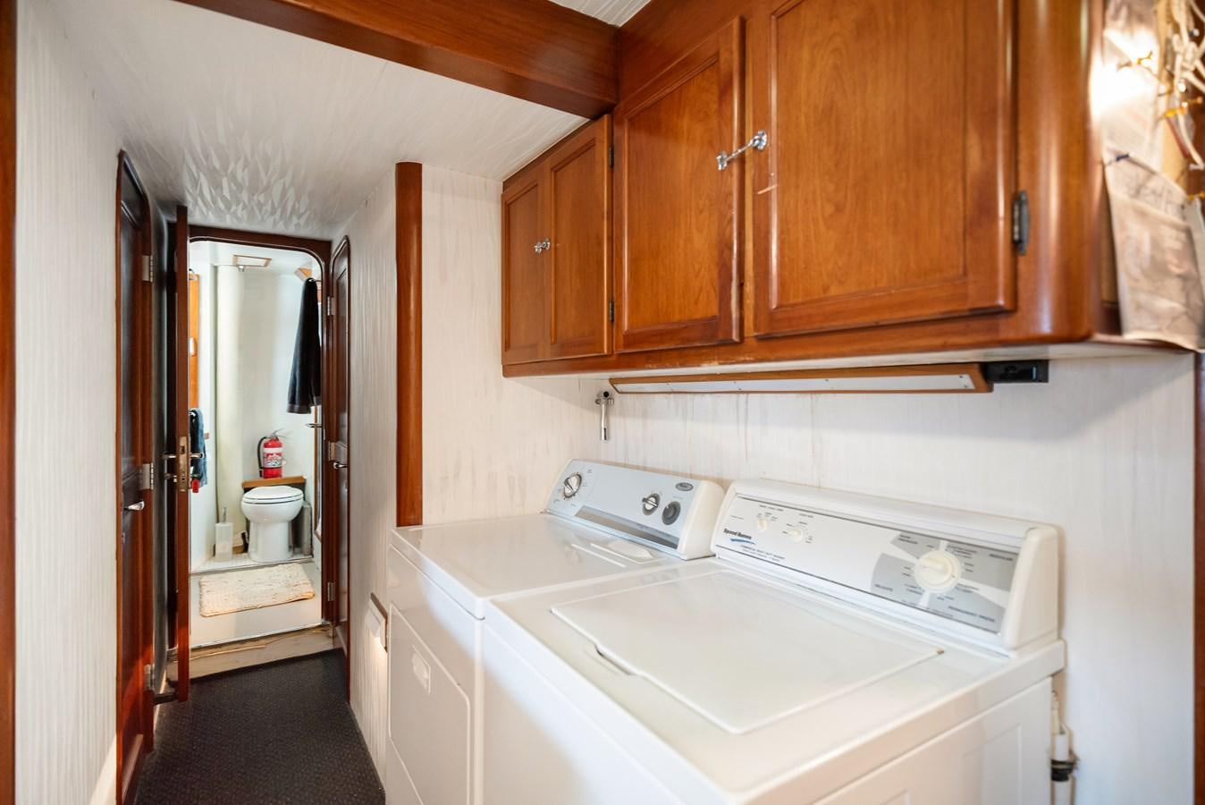 a kitchen with wooden cabinets aboard HUNTRESS Yacht for Sale