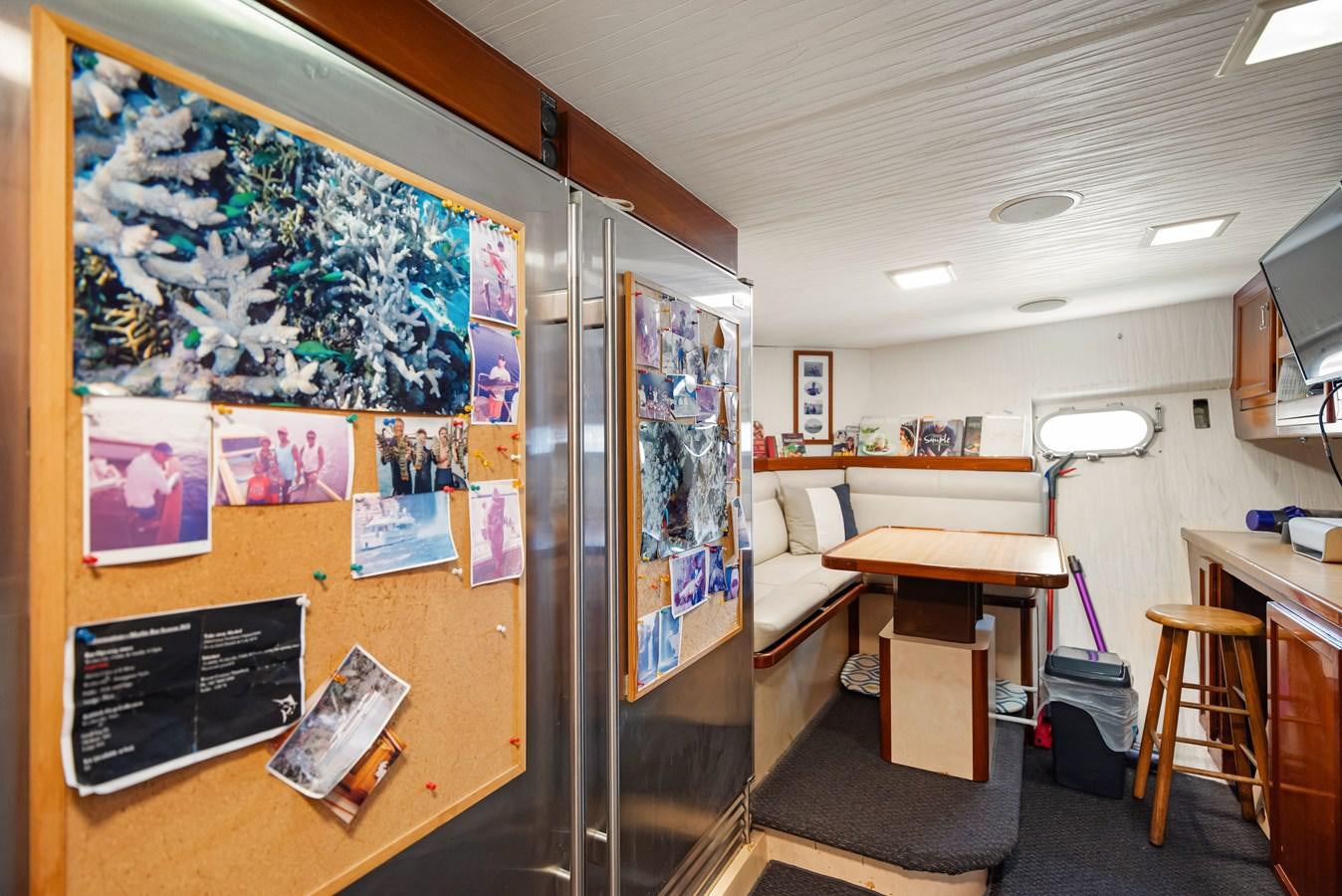 a room with a desk and a bed aboard HUNTRESS Yacht for Sale
