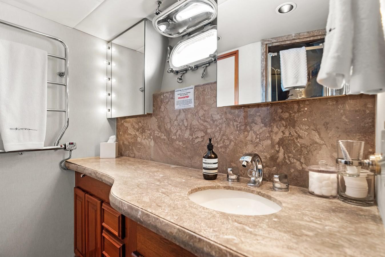 a bathroom with a countertop sink and mirror aboard HUNTRESS Yacht for Sale