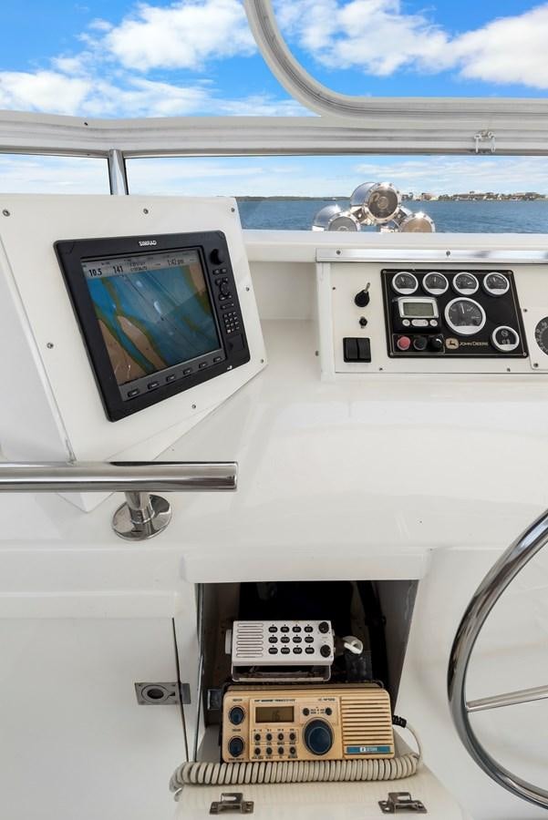 a white vehicle with a screen and buttons and a monitor on the side aboard HUNTRESS Yacht for Sale