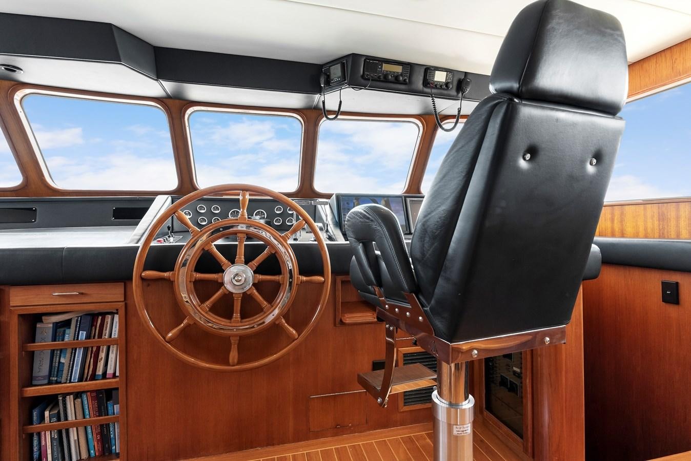 a wooden steering wheel in a vehicle aboard HUNTRESS Yacht for Sale