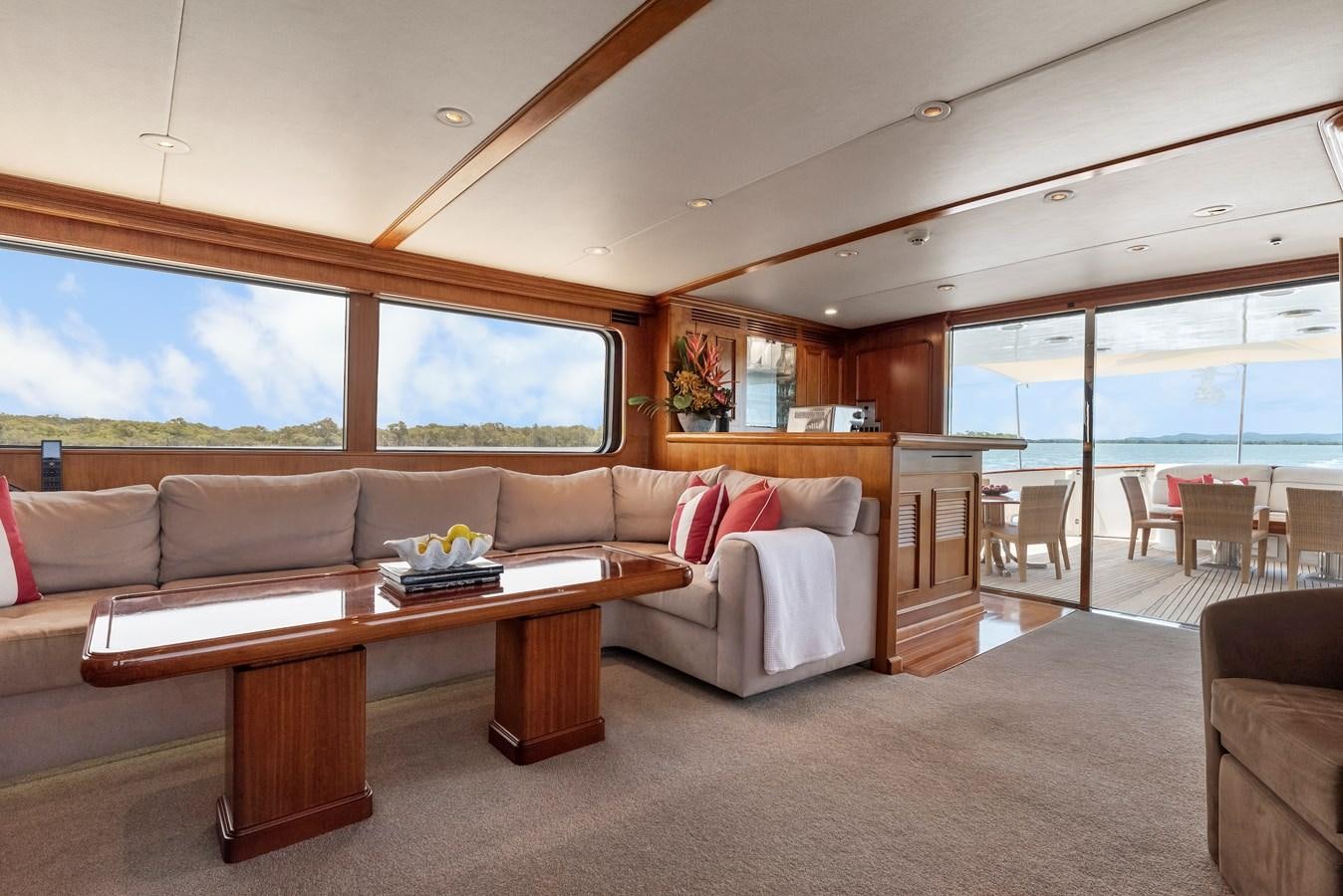 a living room with a couch and a table aboard HUNTRESS Yacht for Sale