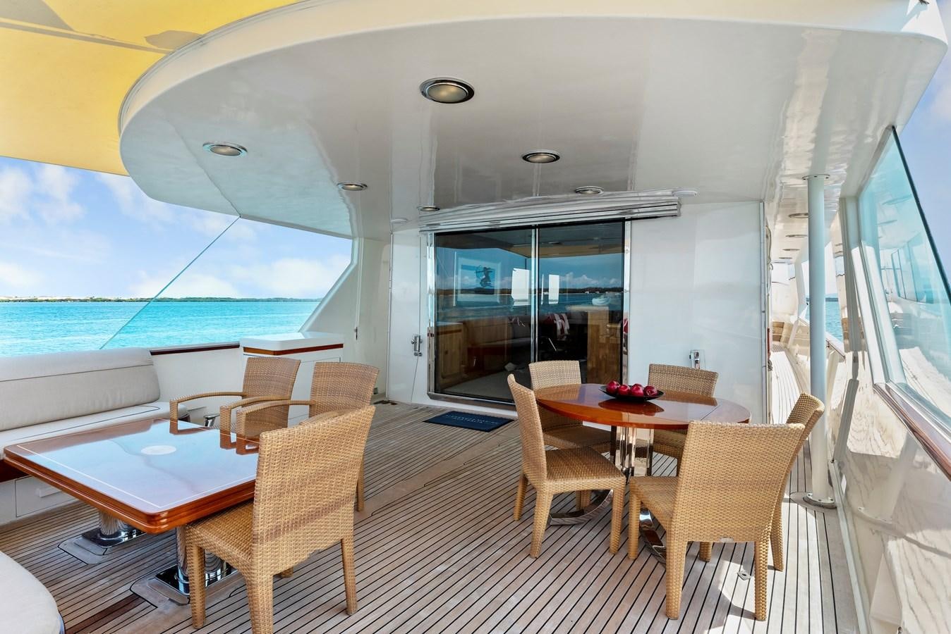 a large room with a table and chairs and a large swimming pool aboard HUNTRESS Yacht for Sale