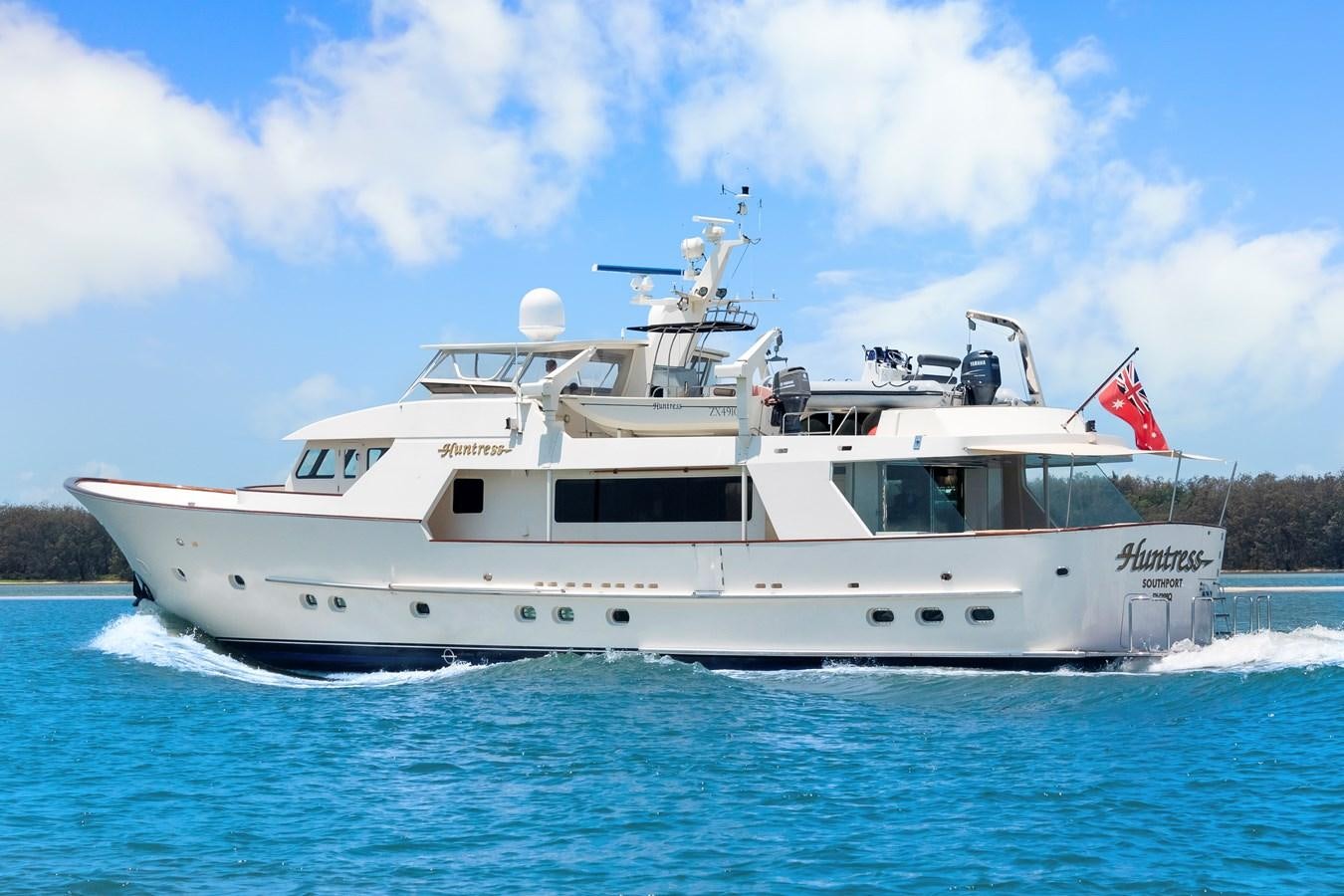 a large white boat on the water aboard HUNTRESS Yacht for Sale