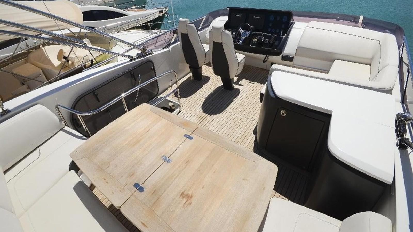 a boat with a desk and chairs aboard NAVY Yacht for Sale