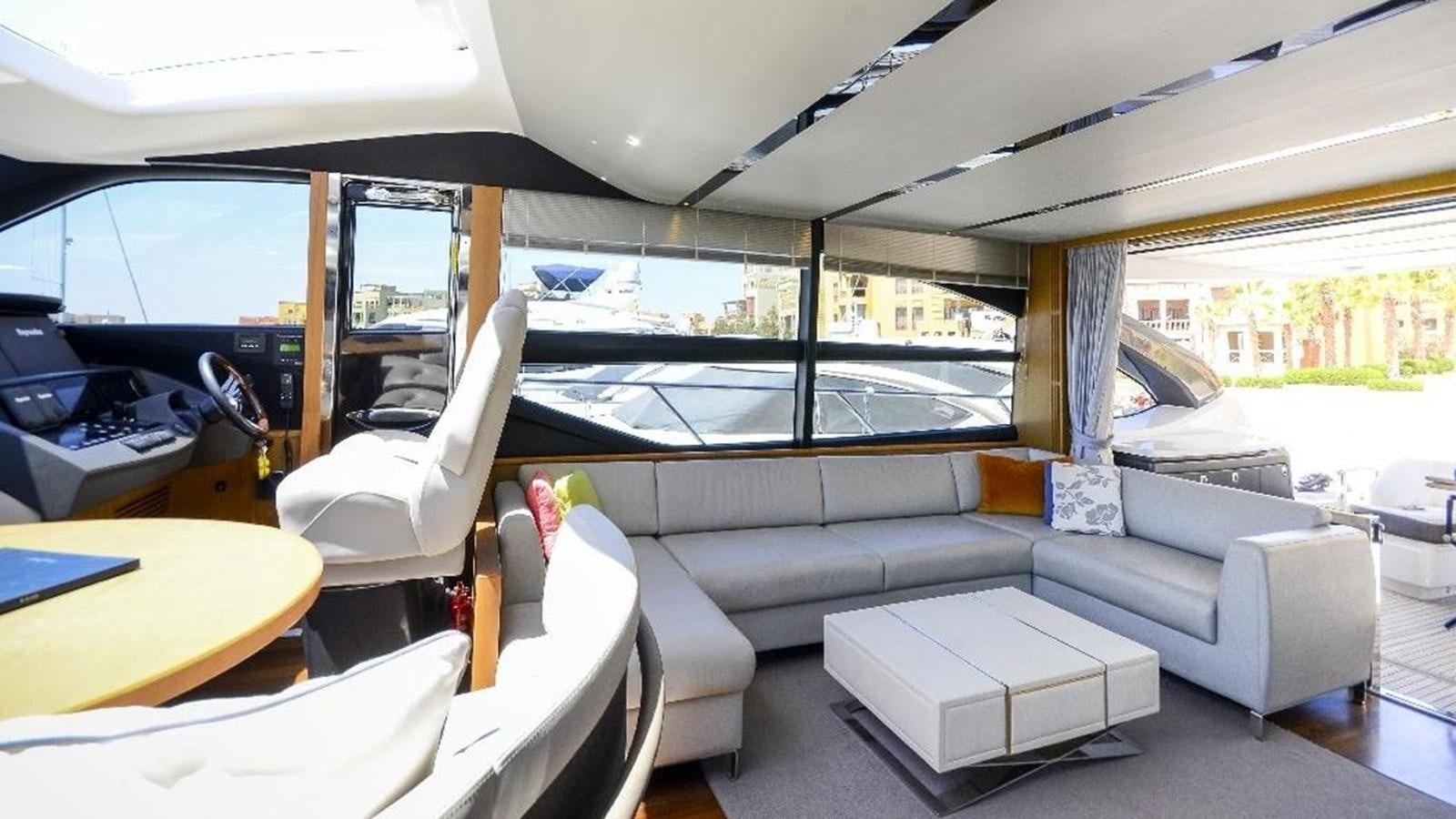 a room with a couch and a table and a large window aboard NAVY Yacht for Sale