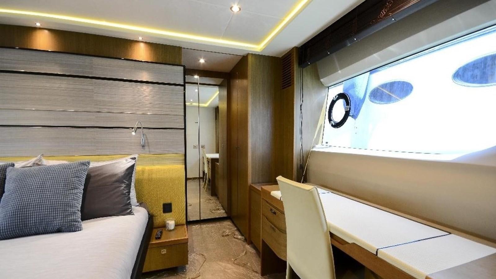 a room with a bed and a desk aboard NAVY Yacht for Sale
