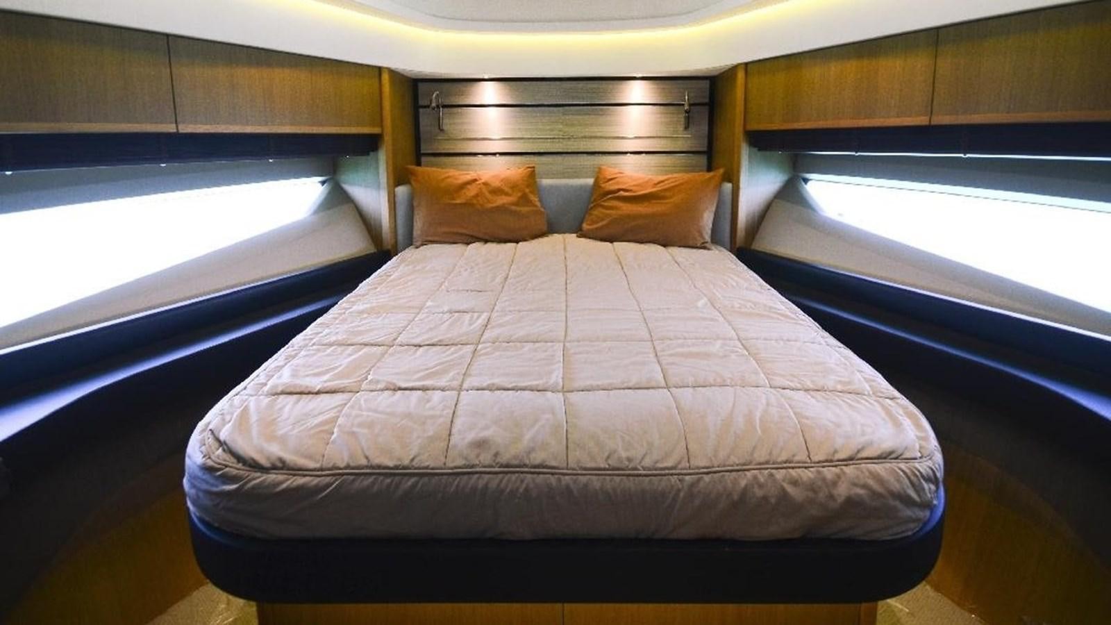 a bed in a room aboard NAVY Yacht for Sale
