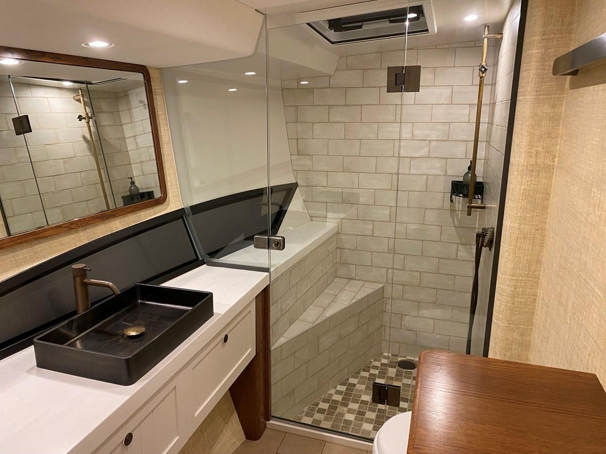 a bathroom with a tub sink and a shower unit aboard THE KEYS Yacht for Sale