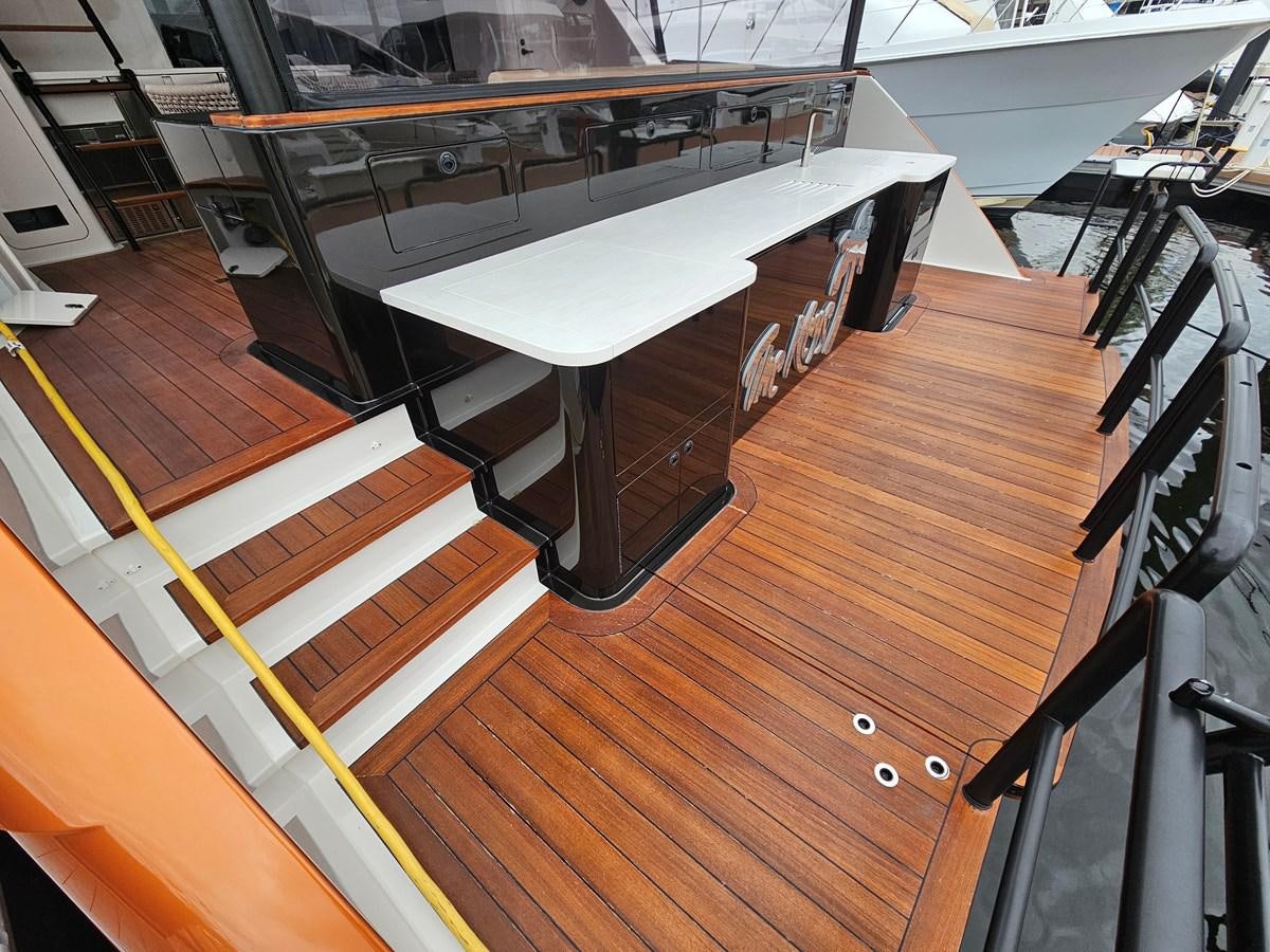 a large white table on a wooden floor aboard THE KEYS Yacht for Sale