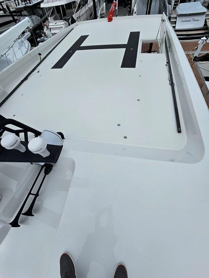 a white vehicle with a black logo aboard THE KEYS Yacht for Sale