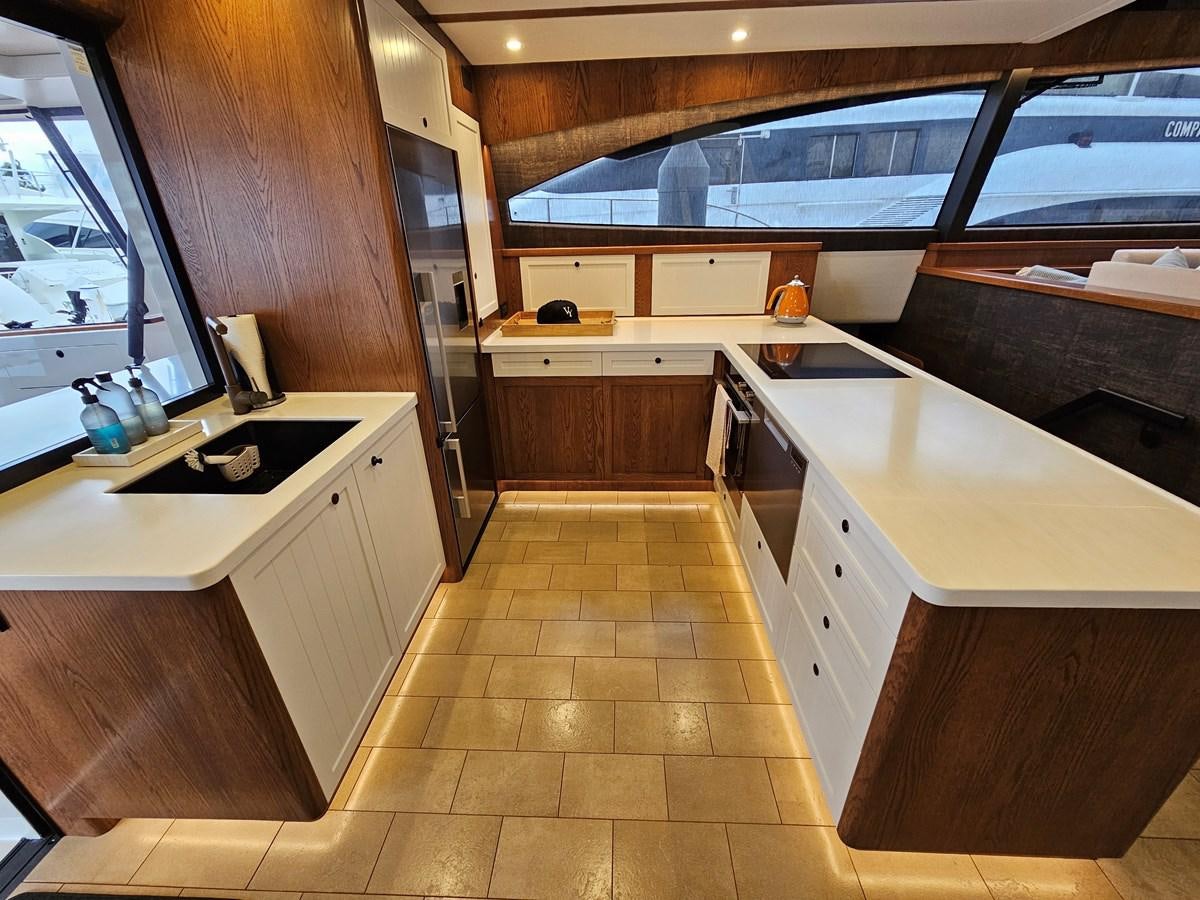 a kitchen with wooden cabinets aboard THE KEYS Yacht for Sale