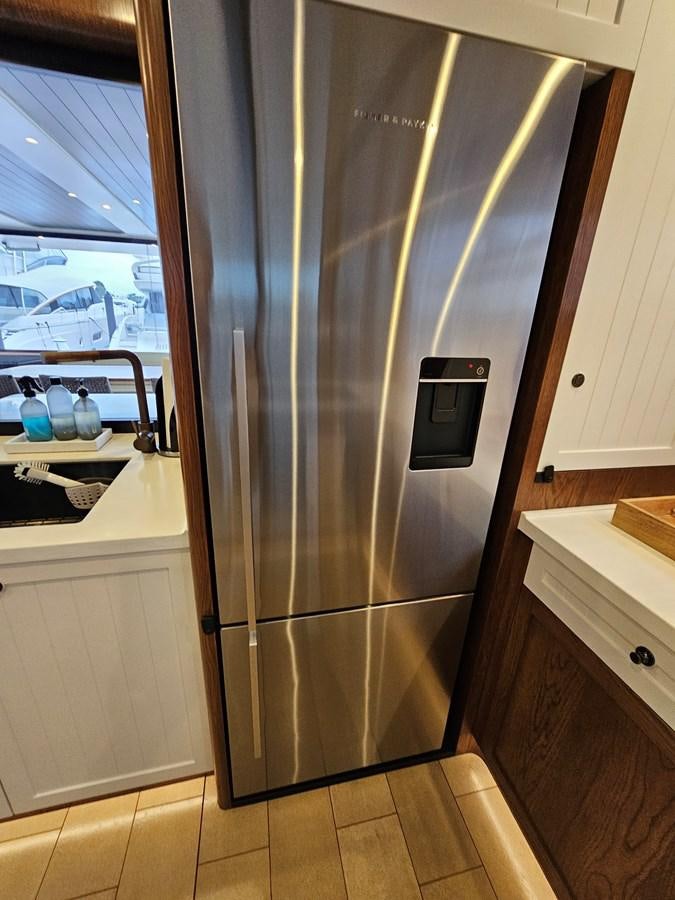 a silver refrigerator in a kitchen aboard THE KEYS Yacht for Sale