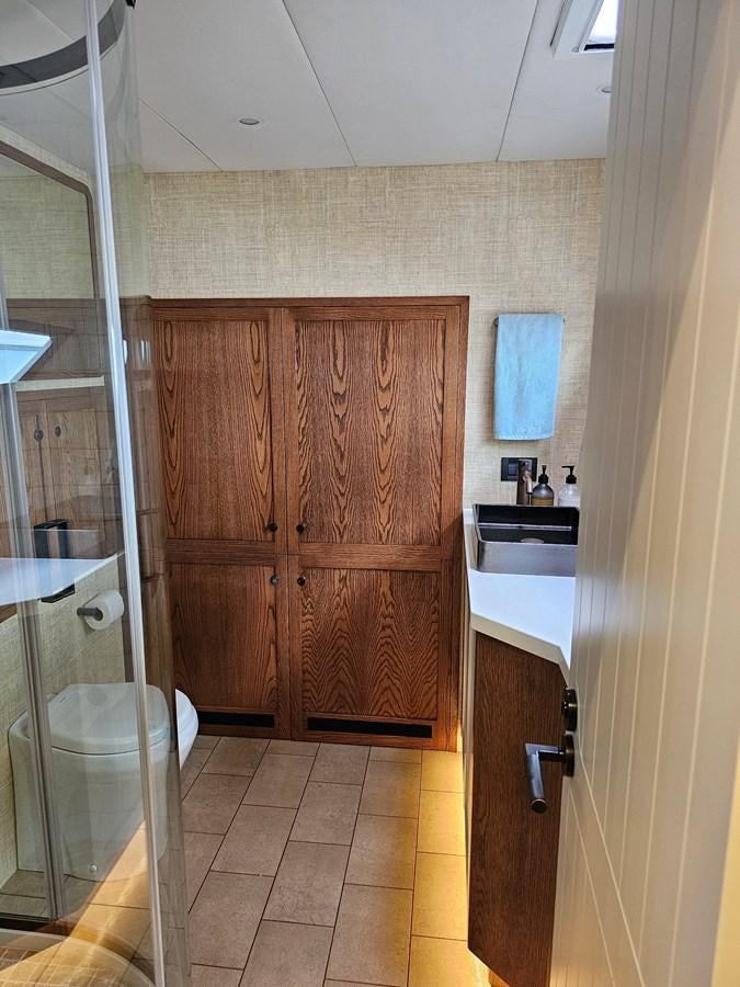 a bathroom with wooden cabinets aboard THE KEYS Yacht for Sale