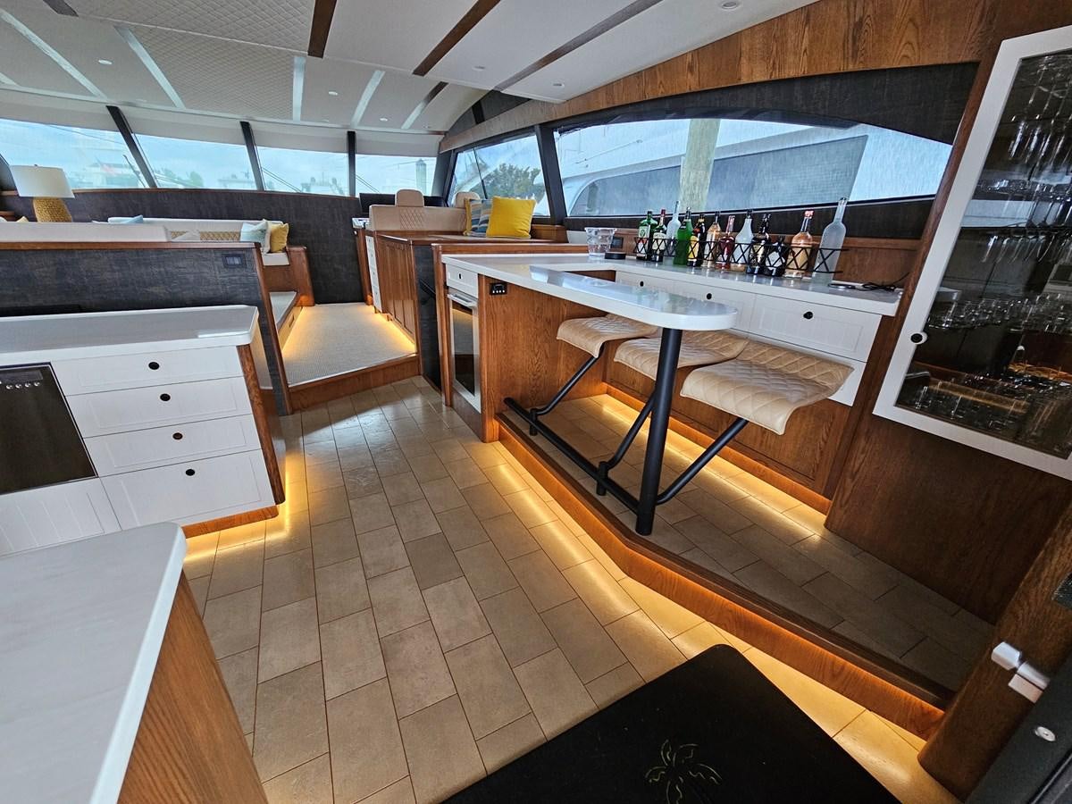 a kitchen with a bar and a bar aboard THE KEYS Yacht for Sale