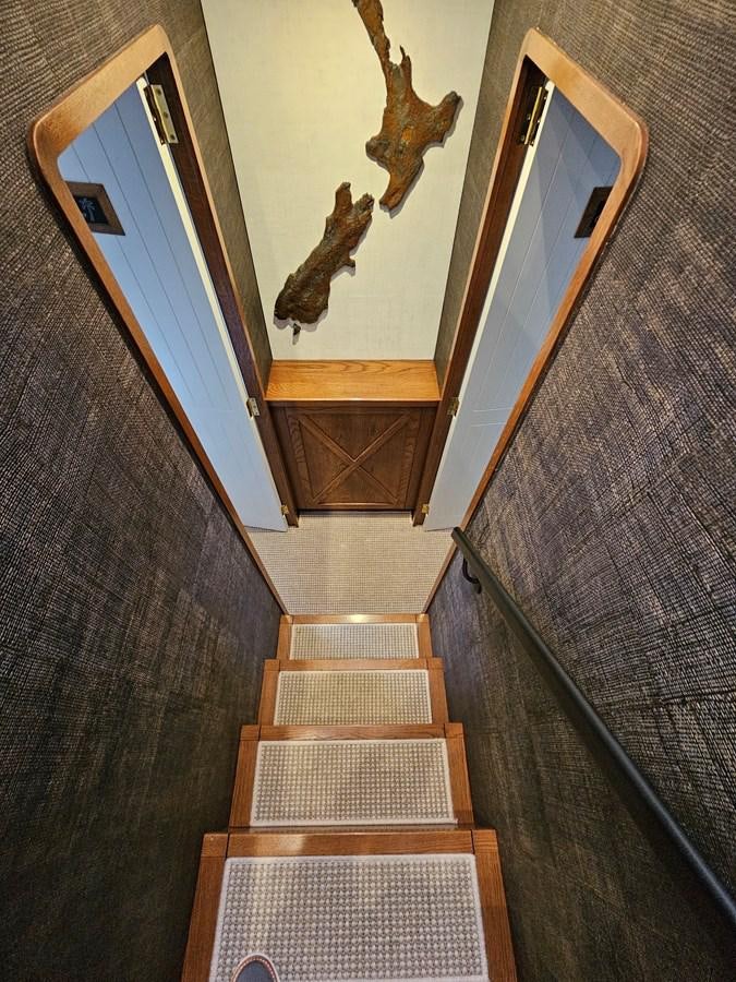 a wooden staircase with a statue aboard THE KEYS Yacht for Sale