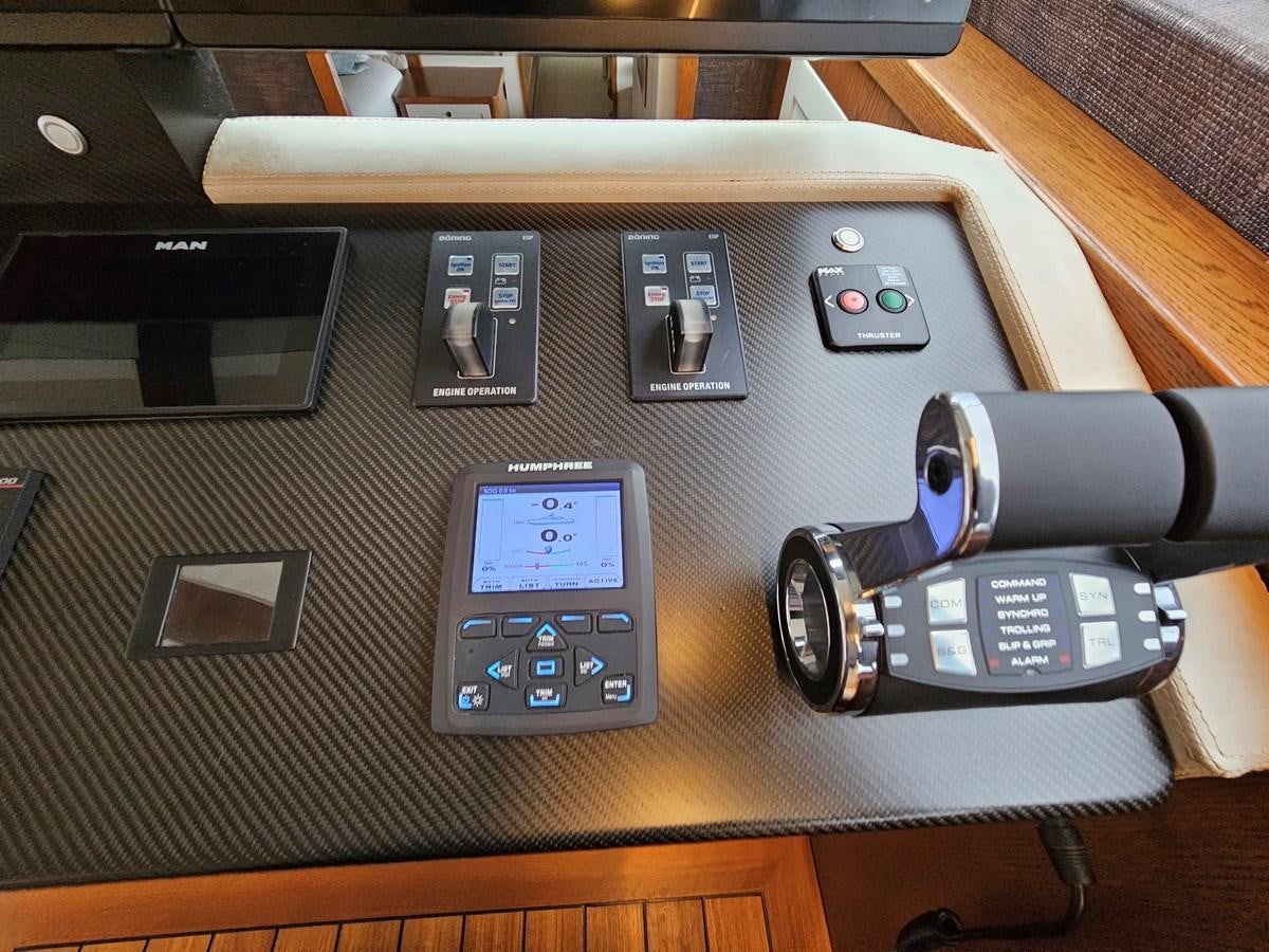 a gun and a remote control on a table aboard THE KEYS Yacht for Sale