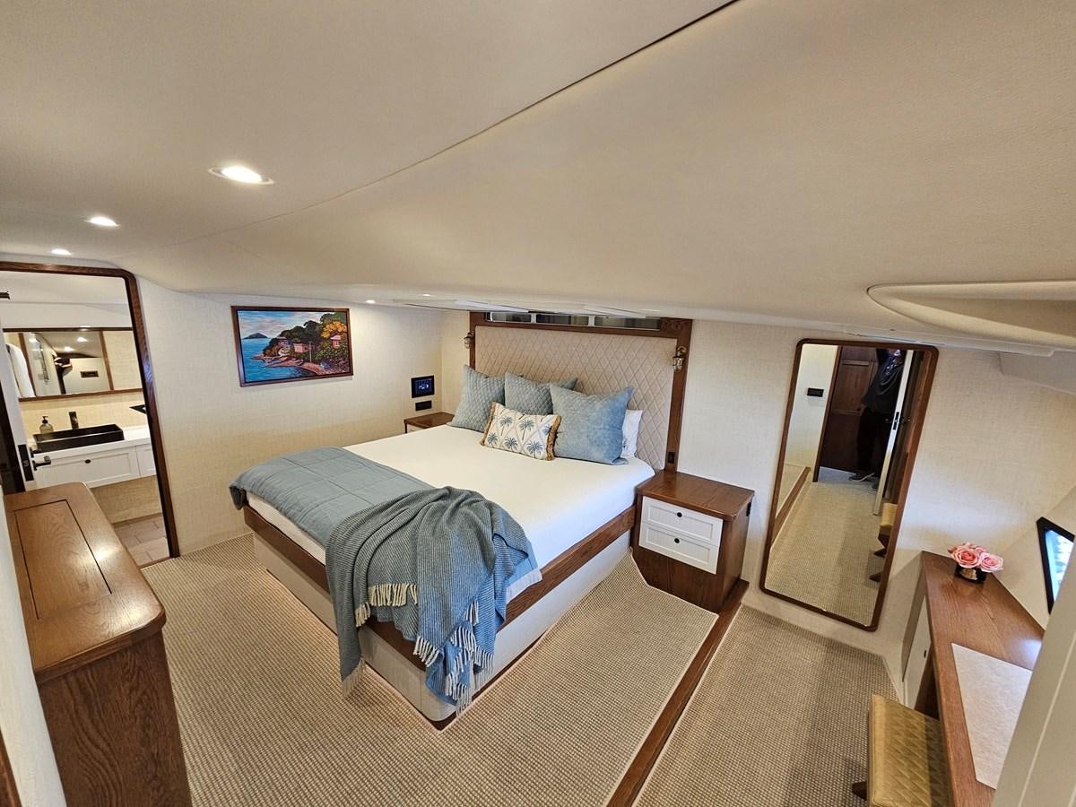 a bedroom with a bed and a desk aboard THE KEYS Yacht for Sale