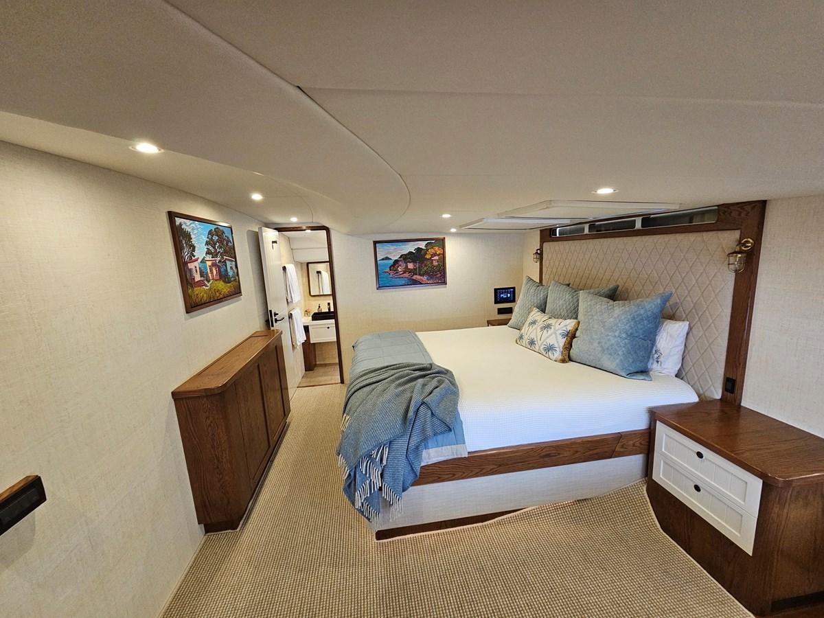 a bedroom with a bed and a desk aboard THE KEYS Yacht for Sale