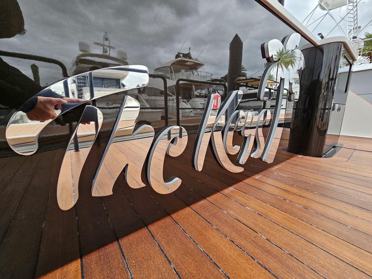 a large wooden deck with a large ship in the background aboard THE KEYS Yacht for Sale