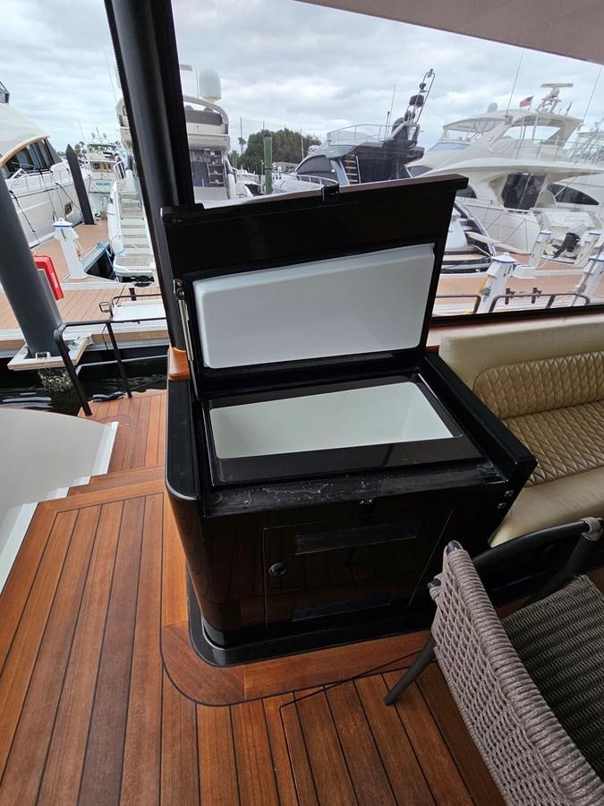 a black piano on a wood deck aboard THE KEYS Yacht for Sale