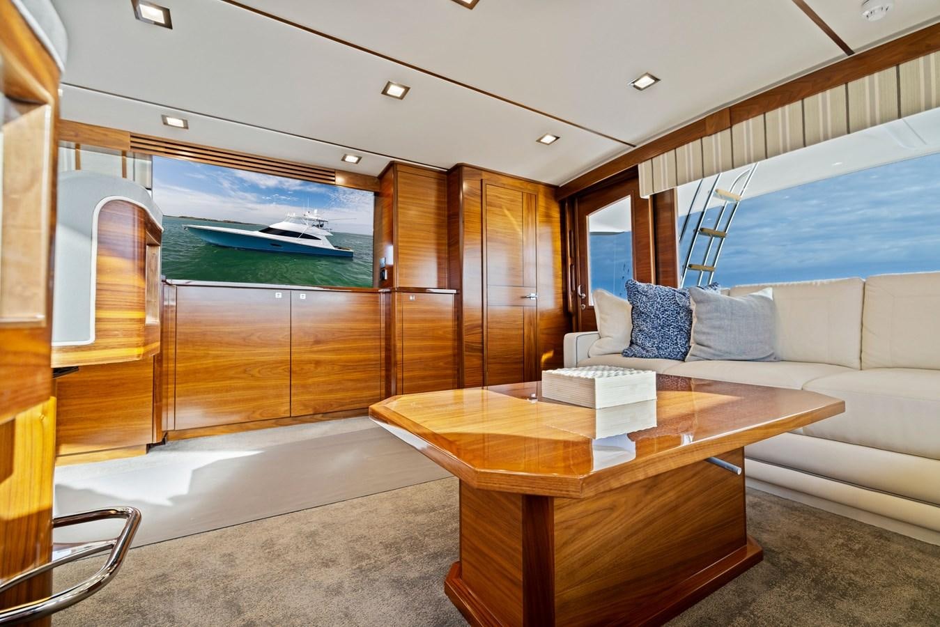 a living room with a table and couches aboard ZATARA Yacht for Sale