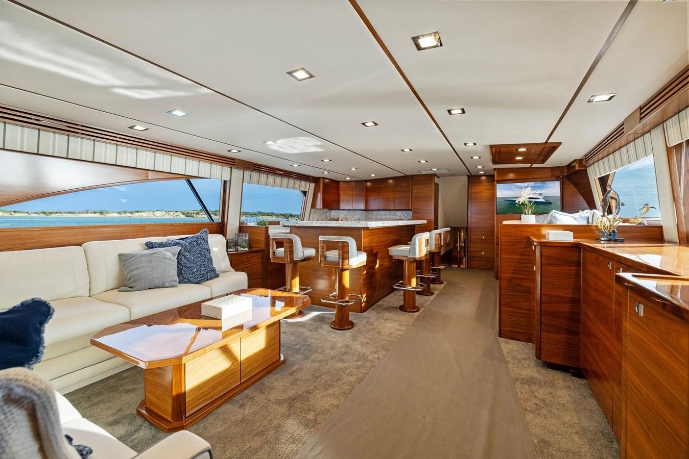 a room with a couch and a table and a large window aboard ZATARA Yacht for Sale