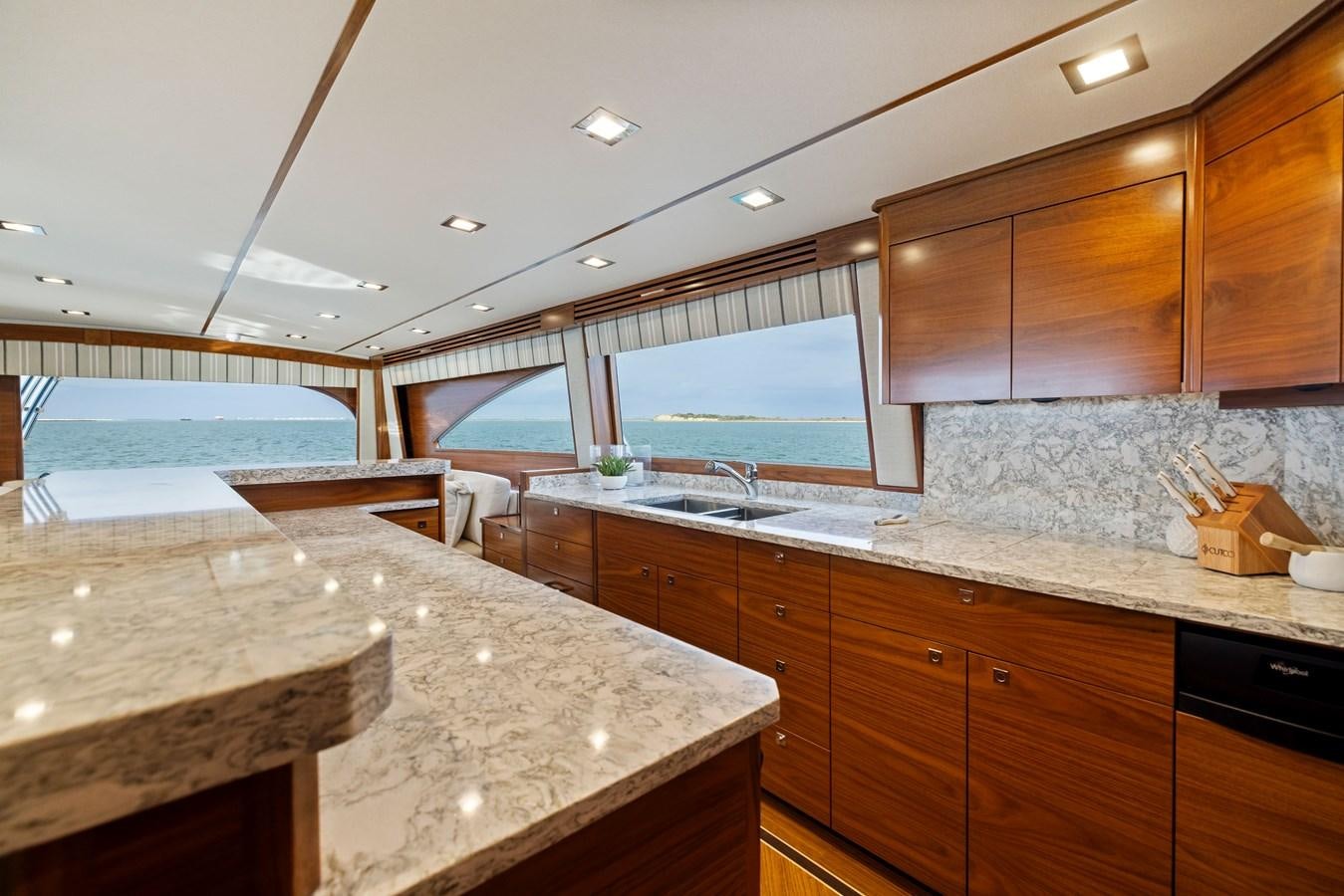 a kitchen with wooden cabinets aboard ZATARA Yacht for Sale