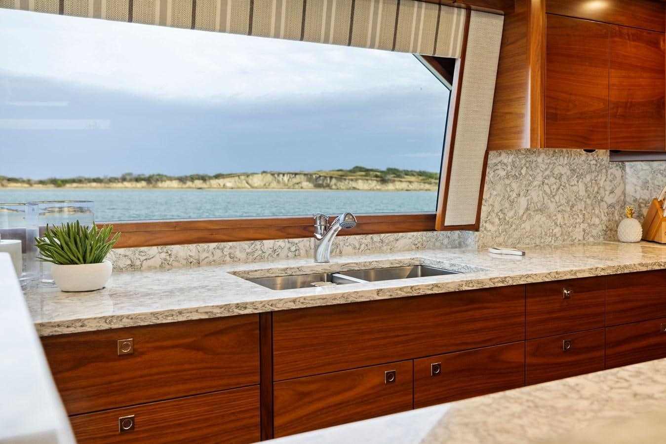 a kitchen with a large window aboard ZATARA Yacht for Sale