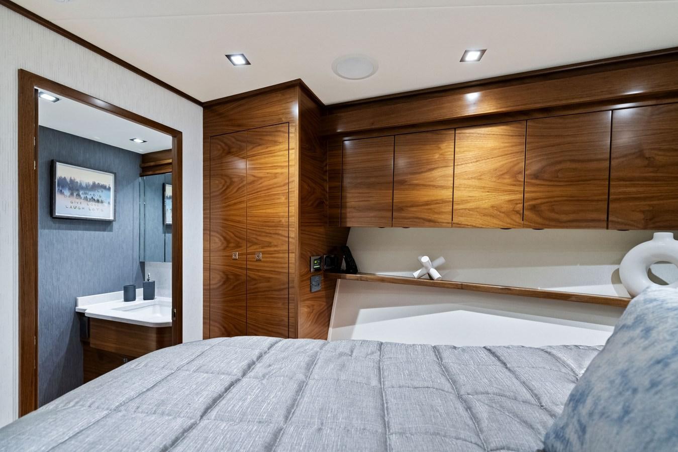 a bedroom with a bed and a mirror aboard ZATARA Yacht for Sale