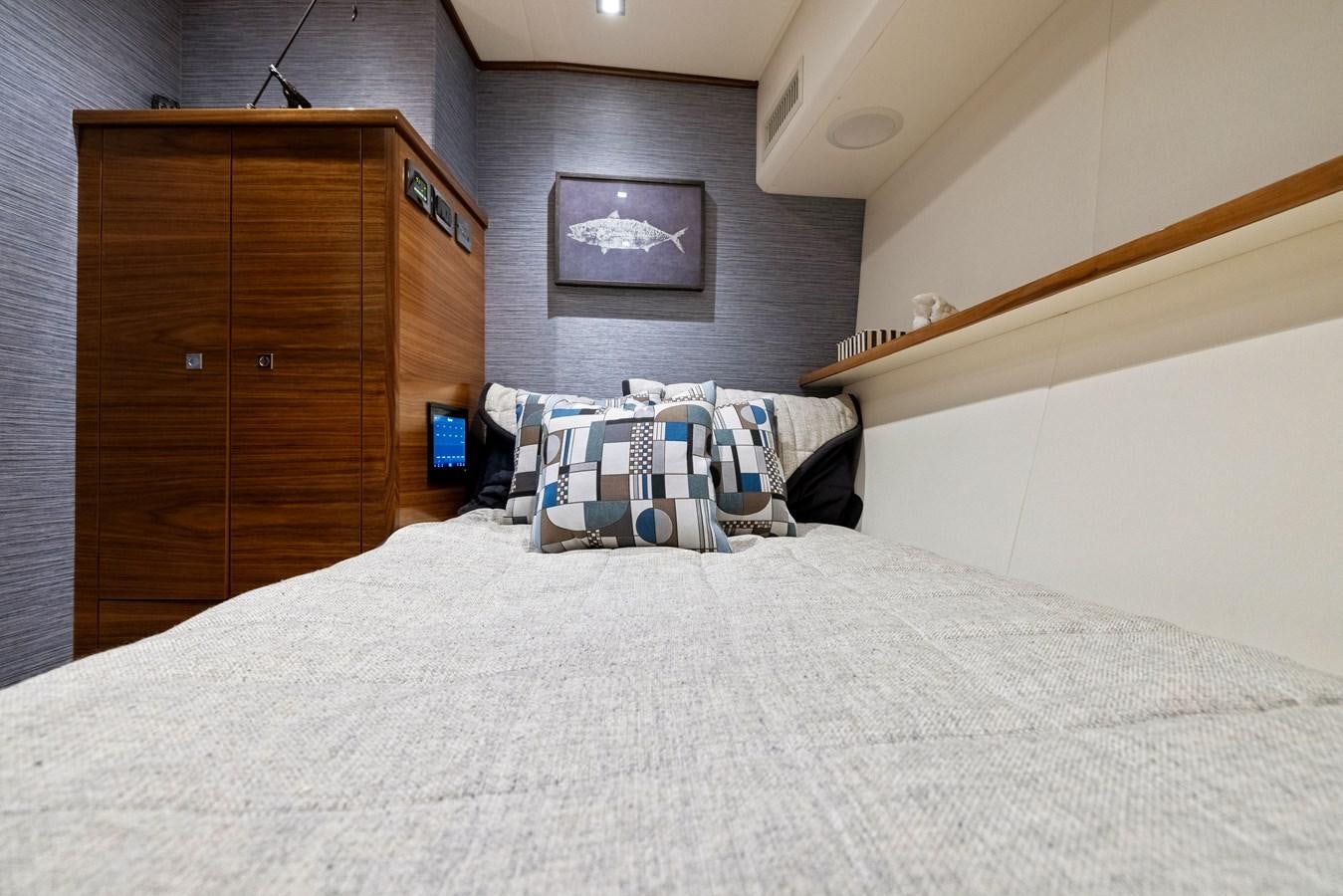 a bed with a white comforter aboard ZATARA Yacht for Sale