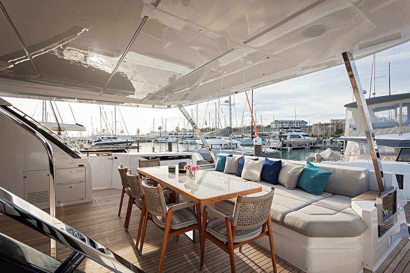 a table and chairs on a deck aboard ANINHA I Yacht for Sale