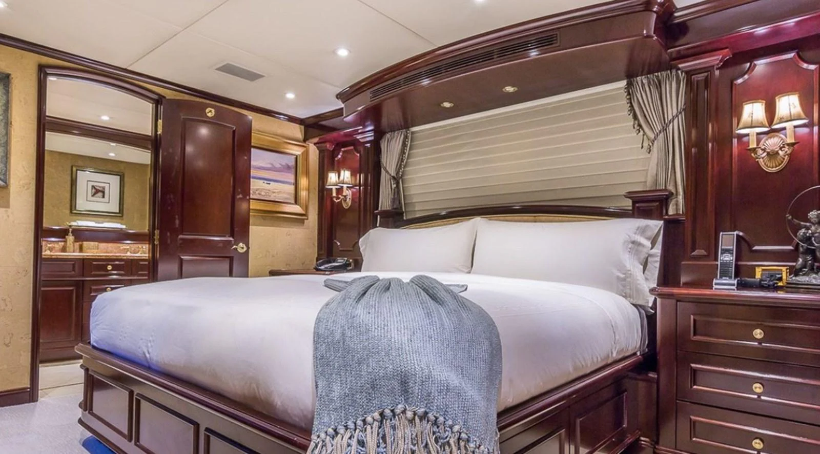 a bed with a blue blanket aboard TRUE LOVE Yacht for Sale