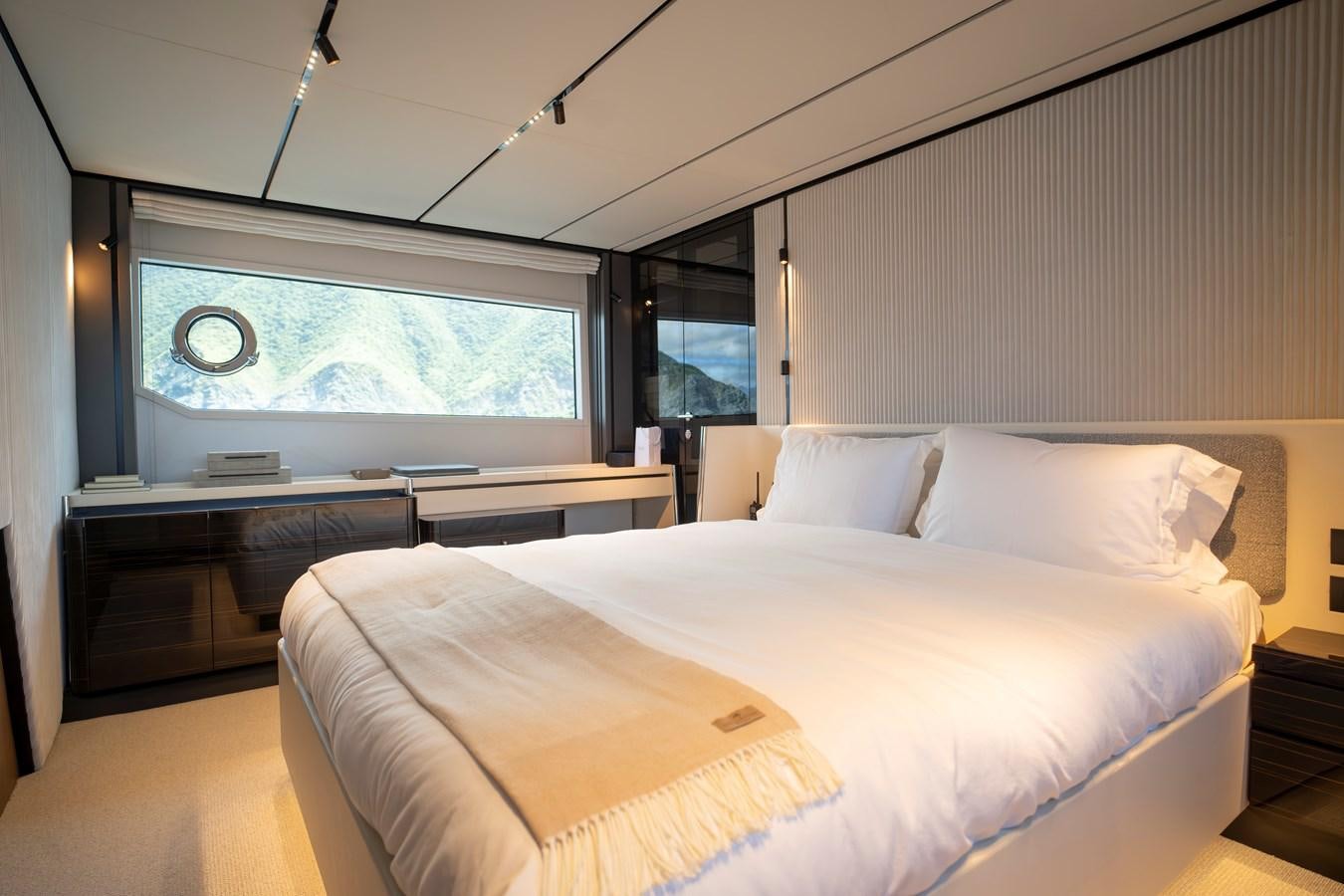 a room with a bed and a desk aboard SILVER MOON Yacht for Sale