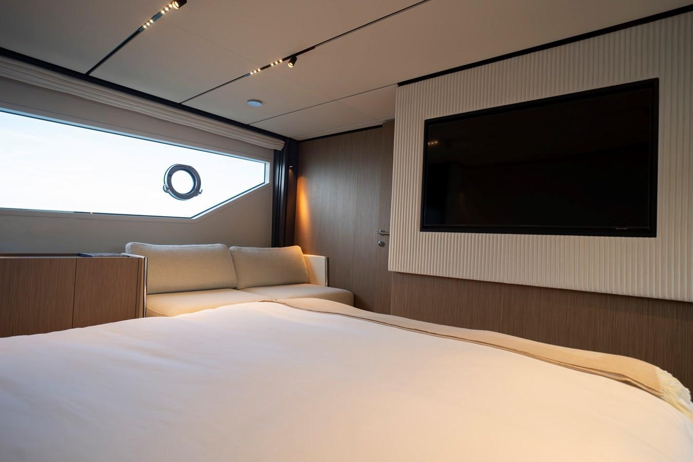 a bed with a tv on the wall aboard SILVER MOON Yacht for Sale