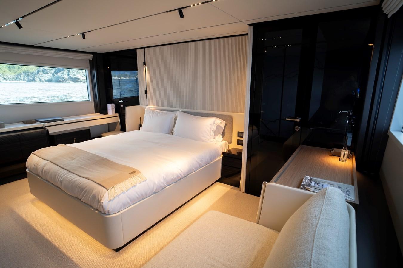 a room with a bed and a desk aboard SILVER MOON Yacht for Sale