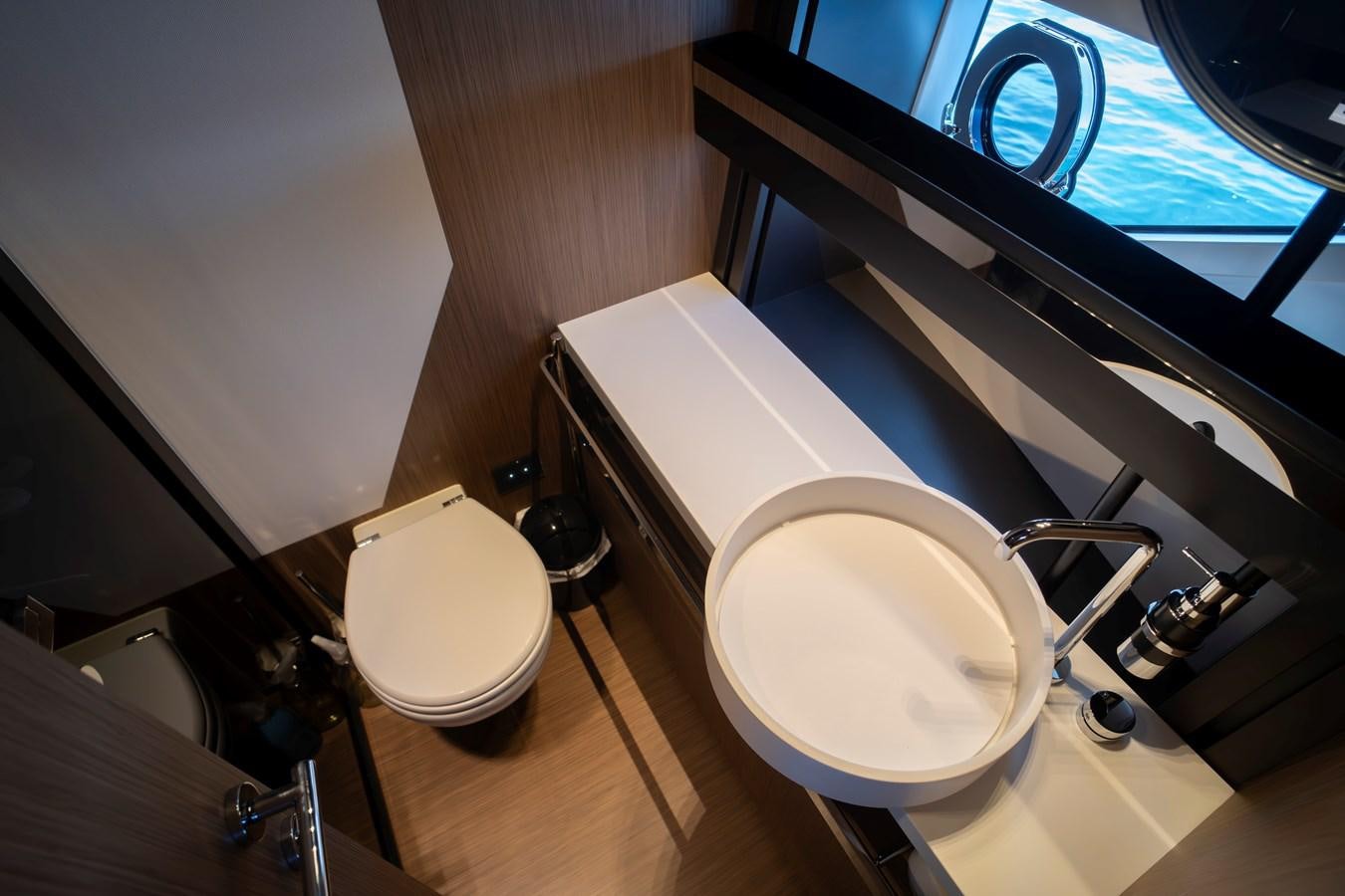 a bathroom with a toilet and a sink aboard SILVER MOON Yacht for Sale