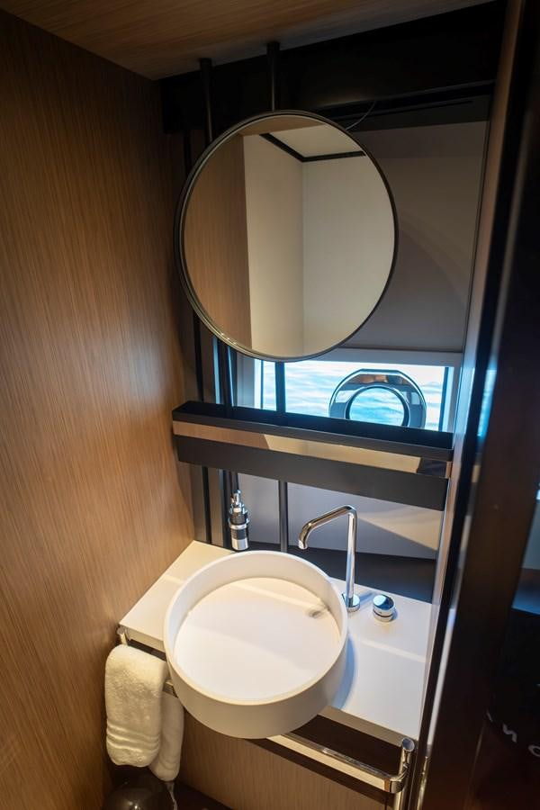 a bathroom with a round mirror aboard SILVER MOON Yacht for Sale