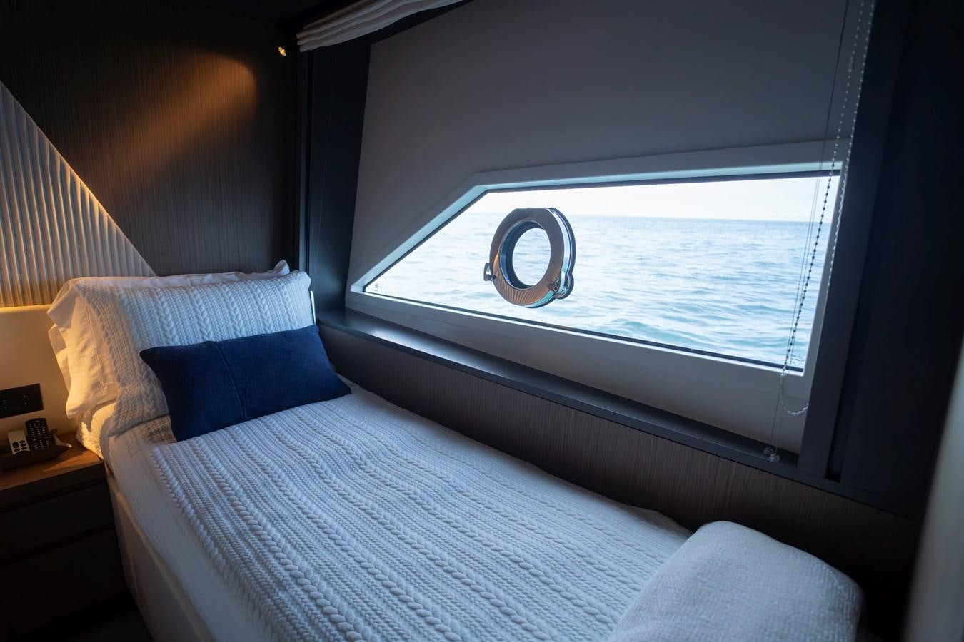 a bed with a large window aboard SILVER MOON Yacht for Sale
