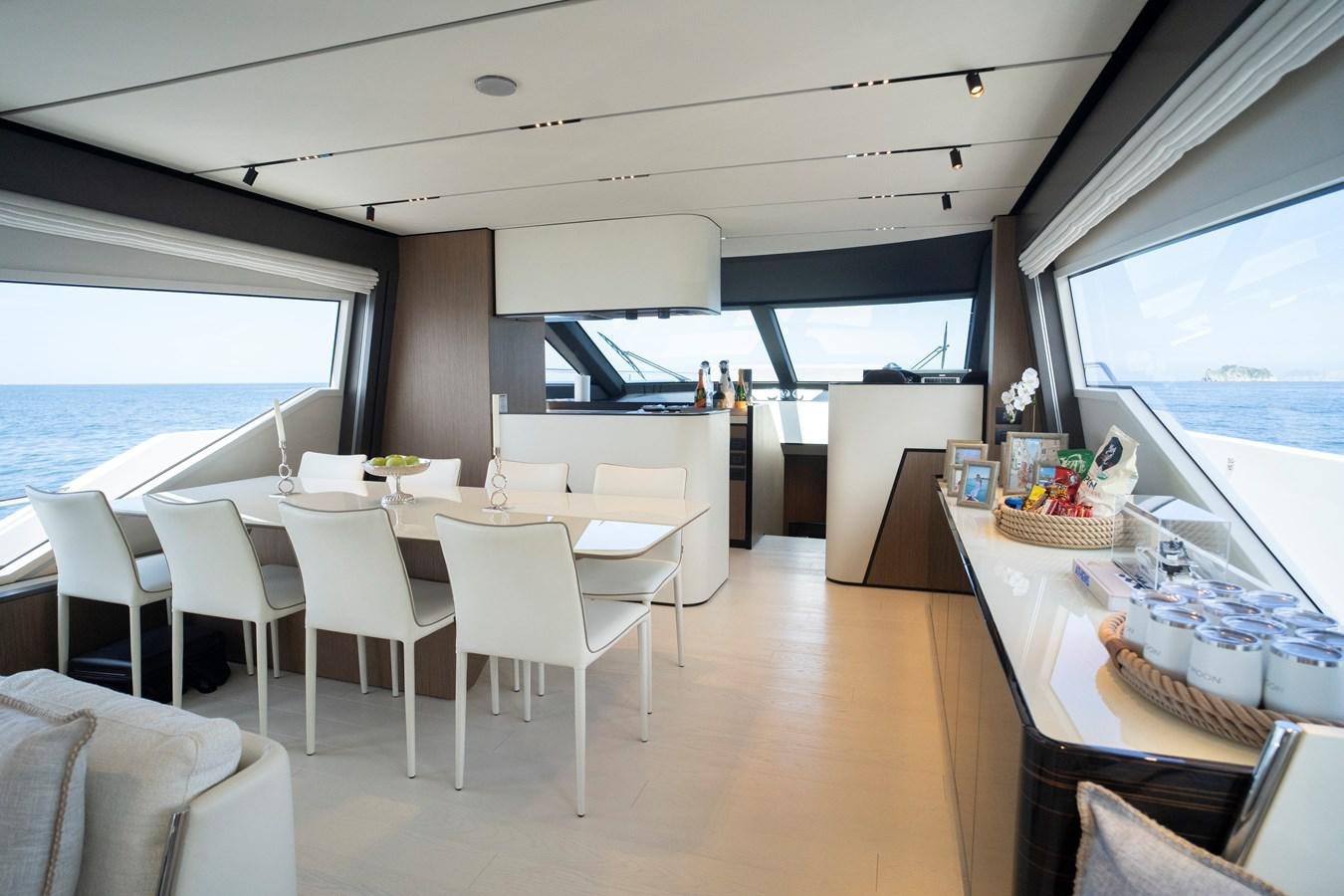a room with tables and chairs aboard SILVER MOON Yacht for Sale
