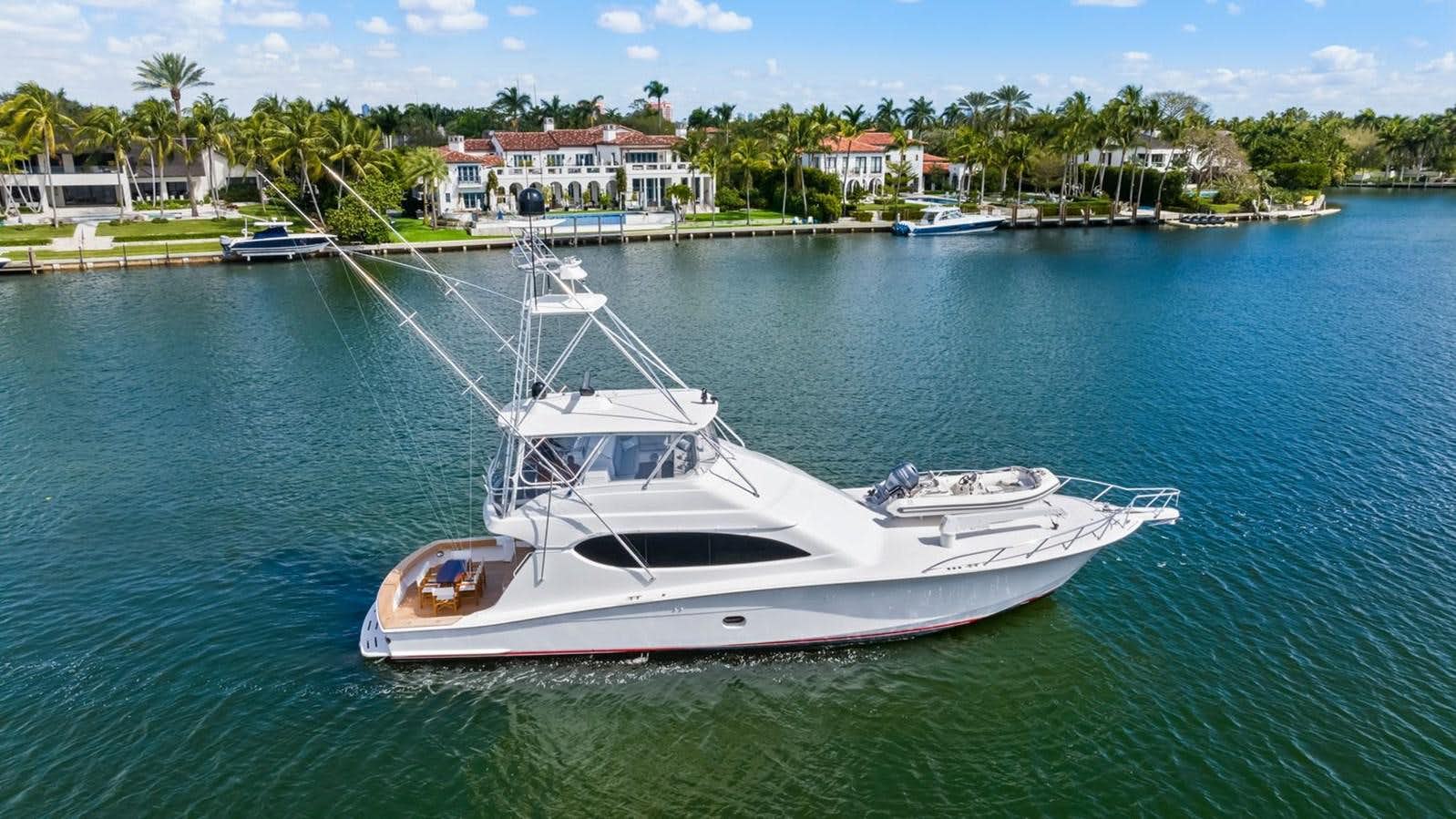 a white boat in the water aboard HATTERAS 64 Yacht for Sale