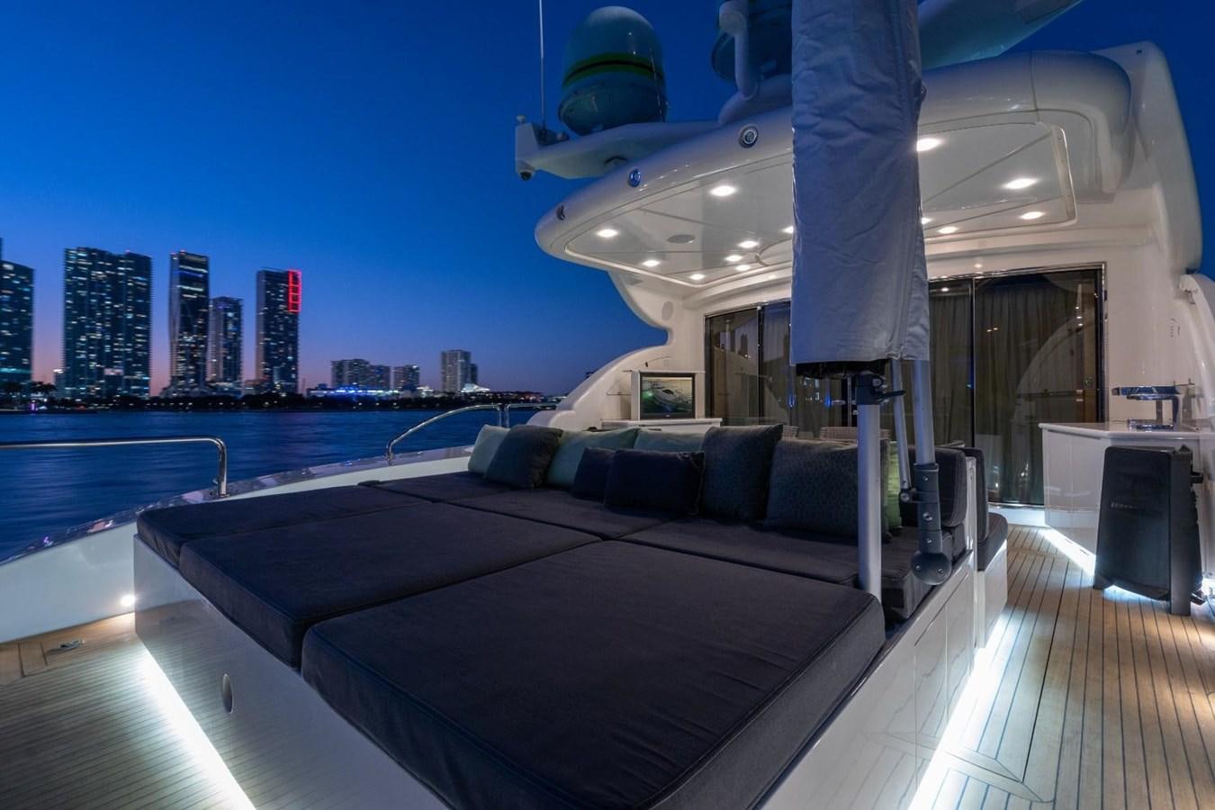 a large lounge chair on a deck overlooking a city aboard LEOPARD Yacht for Sale