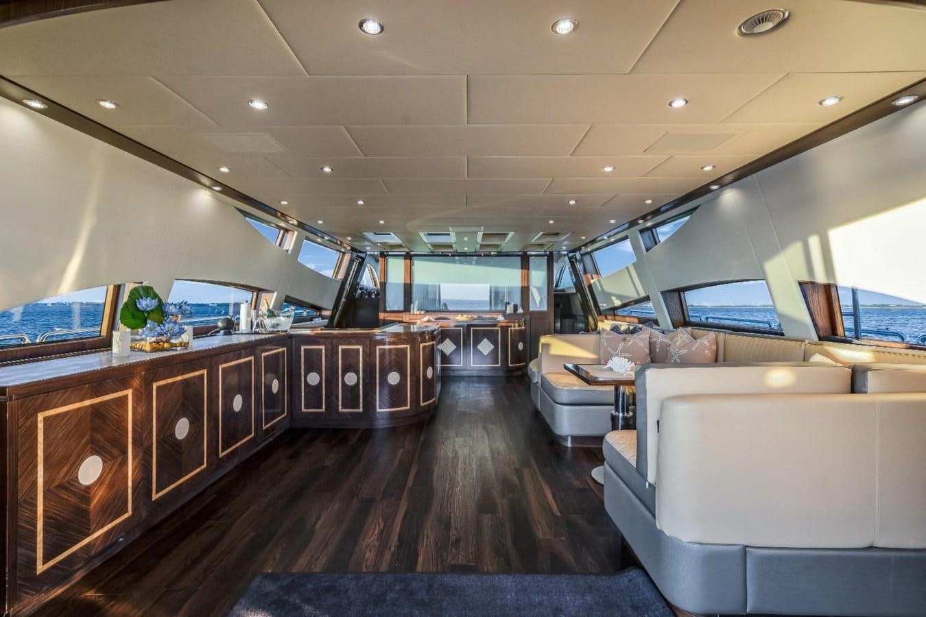 a room with a wood floor and a wood cabinet with white couches aboard LEOPARD Yacht for Sale
